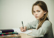 © Marina - teen girl writing at the table on a white background