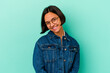 © Asier - Young mixed race woman isolated on blue background confident keeping hands on hips.