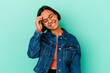 © Asier - Young mixed race woman isolated on blue background joyful laughing a lot. Happiness concept.