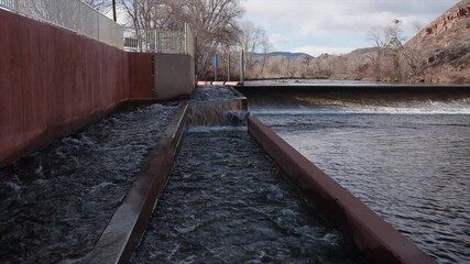 Wall Mural - water flowing through fish ladder at water diversion dam - Watson Lake Dam on the Poudre River in northern Colorado, early spring scenery