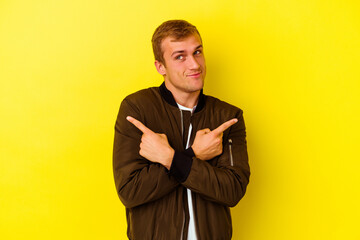 Young caucasian man isolated on yellow background