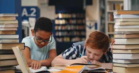 Sticker - Diverse classmates falling asleep on desk with various book in library