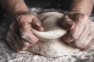 Cooking dough by elderly woman cook hands for homemade pastry bread, pizza, pasta recipe preparation on table background.