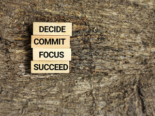 Wall Mural - Inspirational and Motivational Concept - decide commit focus succeed on wooden blocks background. Stock photo.