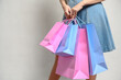 © ell - Young happy summer shopping woman with shopping bags isolated on grey background