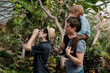 © Елена Григорович - Adventurous family inspecting tropical gallery in Botanical garden. Local travel