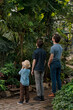 © Елена Григорович - Adventurous family inspecting tropical gallery in Botanical garden. Local travel