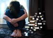 Cyberbullying - social media harassment concept. Young asian preteen, teenager boy sitting alone in the room feeling frustrated after reading bad comments. Text emoticons, Teen mental health, Online.