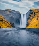 Beautiful autumn scenery. Picturesque morning view of Skogafoss Waterfall. Great autumn scene of Skoga river. Amazing landscape of Iceland, Europe. Beauty of nature concept background.