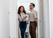 © Zoran Zeremski - Smiling couple with suitcase arriving in hotel room.