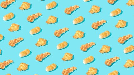 Trendy pattern made of three different types of fresh pastries on sunny blue.  Minimal bakery background idea.