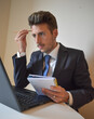 © Andrea - businessman in suit working at computer.