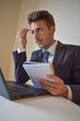© Andrea - businessman in suit working at computer.