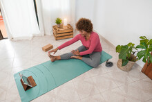 African Senior Woman Doing Online Yoga Class At Home - Healthy Lifestyle And Joyful Elderly Concept - Focus On Face