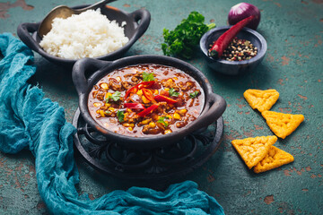 Wall Mural - Hot Mexican Chili con carne with rice and tortilla chips and spices