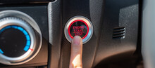 Finger Press A Car Ignition Button Or START Engine Inside Modern Electric Automobile. Keyless, Change, Strategy, Vision, Innovation And Future Concept