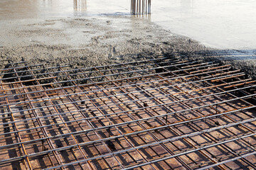 Pouring concrete on the floor of a building under construction.