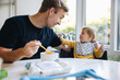 © Jacob Lund - Man on paternity leave feeding his baby