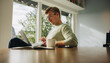 © Jacob Lund - Man at home using laptop