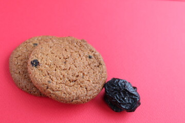 homemade oatmeal with prunes on a red background with room for text