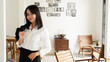 © HumbaFrame - Beautiful young asian business woman in suit standing at cafe