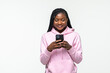 © F8  \ Suport Ukraine - Happy african woman texting on her phone isolated over white background