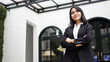 © HumbaFrame - Asian business woman smiling and standing in front office