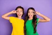 Photo Of Two Little Boy And Girl Make Funny Face Tongue Out Show V-sign Isolated On Purple Color Background