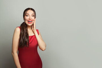 Happy surprised woman in red silky dress on white banner background