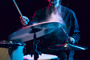 Drummer's rehearsing on drums before rock concert. Man recording music on drumset in studio