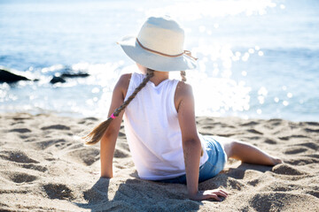 child in ha enjoying on sandy beach of sea coast