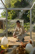 © ULTRAPOK - A Thai government officer, Civil servant is sitting in front of the chicken coop, henhouse.