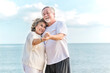 © lukyeee_nuttawut - Happy asian senior retired couple, relax smiling elder man and woman enjoying with retired vacation at sea beach outdoor. Health care, Family outdoor lifestyle