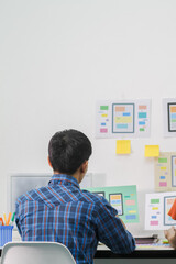 Wall Mural - smooth focus,a team of ui ux web designers are working together to develop a mobile responsive websi