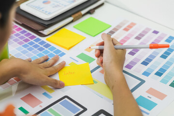 Wall Mural - smooth focus,a team of ui ux web designers are working together to develop a mobile responsive websi