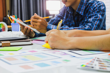 Wall Mural - smooth focus,a team of ui ux web designers are working together to develop a mobile responsive websi