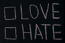 Writing In Chalk On A Rough Board Or Asphalt Love Hate With Checkmark Option. The Concept Of Choosing Between Love And Hate In Different Spheres Of Life. Free Space To Choose Where To Tick