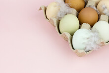 Close Up View Of Raw Multicolored Chicken Eggs With Feathers In Ovum