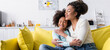 © LIGHTFIELD STUDIOS - happy african american child and mom embracing with closed eyes on couch at home, banner