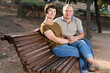 © caftor - elderly man and woman embracing on bench