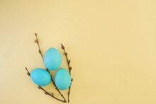 Creative Easter Bouquet Of Pussy Willow Branches And Easter Blue Painted Eggs On Yellow Background With Copy Space, Top View, Flat Lay