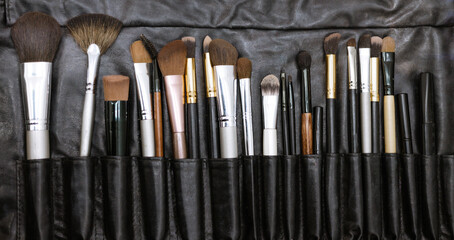 Sticker - set of makeup brushes in a black case, a concept of a make-up and a visit to a beauty salon