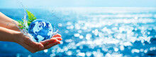 Environment Concept - Hands Holding Globe Glass In Blue Ocean With Defocused Lights