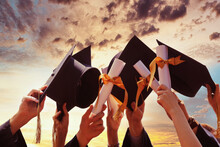 International Students In Mortar Boards And Bachelor Gowns With Diplomas.