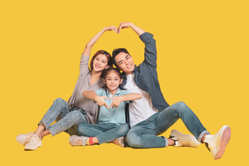 Wall Mural - Happy young  family shaping heart and love with hands