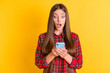 © deagreez - Portrait of nice impressed brunette long hairdo lady look telephone wear red shirt isolated on vivid yellow color background