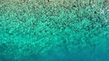 Wall Mural - waves and azure water as a background. view from drone at the ocean surface. natural summer seascape