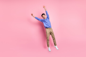 Sticker - Full length photo of funky funny man jump up air fly raise hands isolated on pastel pink color background