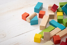 Closeup Of Colorful Wooden Toy Blocks On White Background Wooden Table. The Child Plays With Colored Cubes.