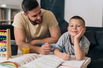 Wall Mural - father and son at home. son do homework